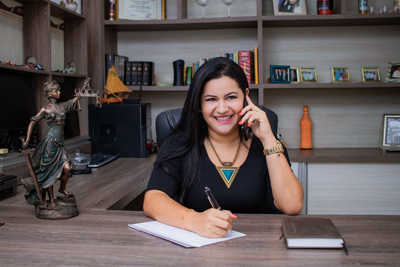 attorney on the phone in her office taking notes