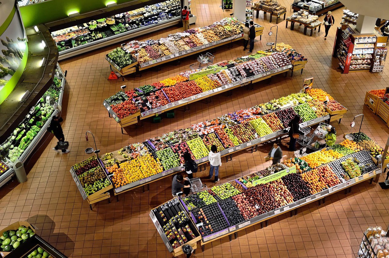 Overhead shot of grocery produce section showing fruits and vegetables.